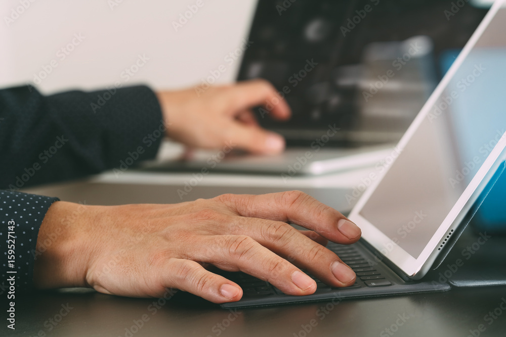 close up of businessman hand working with laptop and digital docking keyboard tablet computer in modern office close up of businessman hand working with laptop and digital docking keyboard tablet computer in modern office