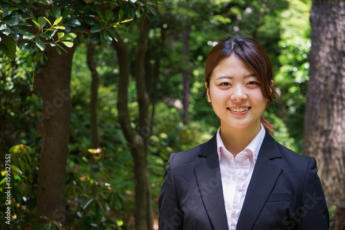 Businesswoman walking outdoors with smile