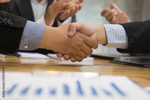 Business people shaking hands after finishing up a meeting. Businessman handshaking after conference. teamwork, partnership, collaboration, corporate concept.