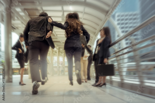 businessman and woman hurry up and running in business city street for rush hour, motion blur background