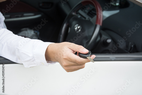 Hand with a car keys in car
