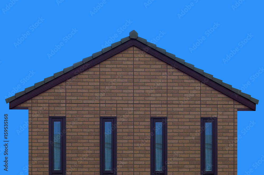 brick house wall gable roof and clear blue sky