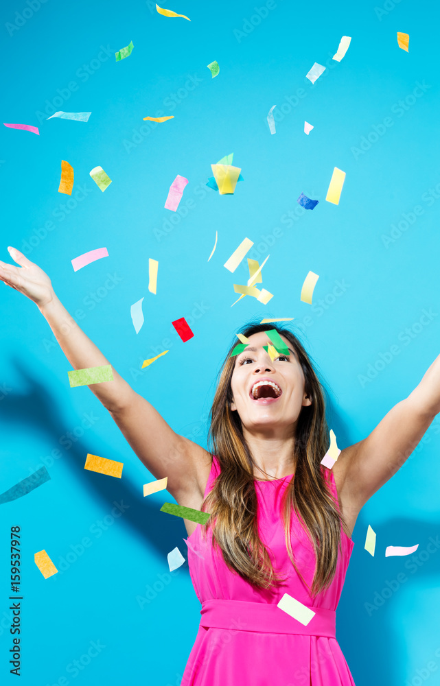 Fototapeta premium Happy woman celebrating with confetti