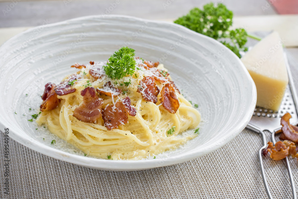 Classic Homemade Pasta Carbonara Italian. Spaghetti with bacon, eggs, parsel and parmesan cheese on white plate Classic Homemade Pasta Carbonara Italian. Spaghetti with bacon, eggs, parsel and parmesan cheese on white plate