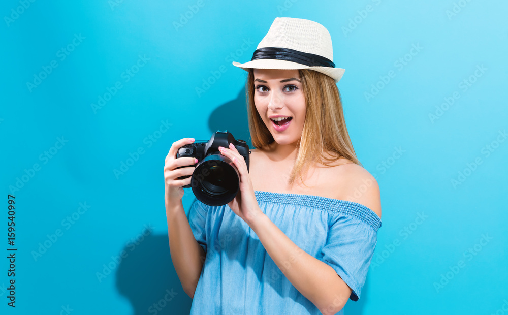Young woman holding a camera