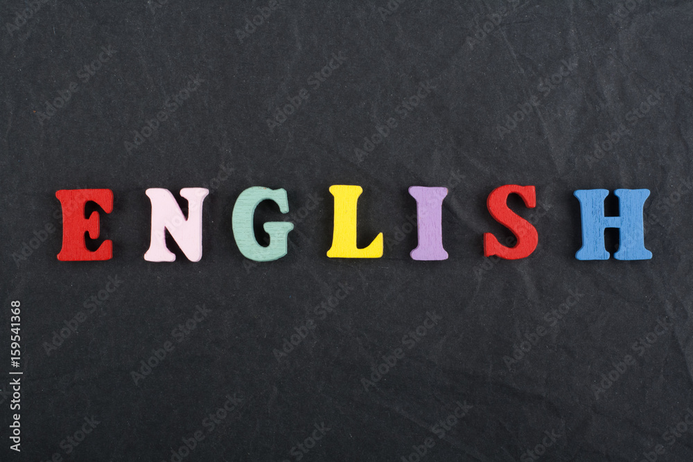 English word on black board background composed from colorful abc alphabet block wooden letters, copy space for ad text. Learning english concept. English word on black board background composed from colorful abc alphabet block wooden letters, copy space for ad text. Learning english concept.