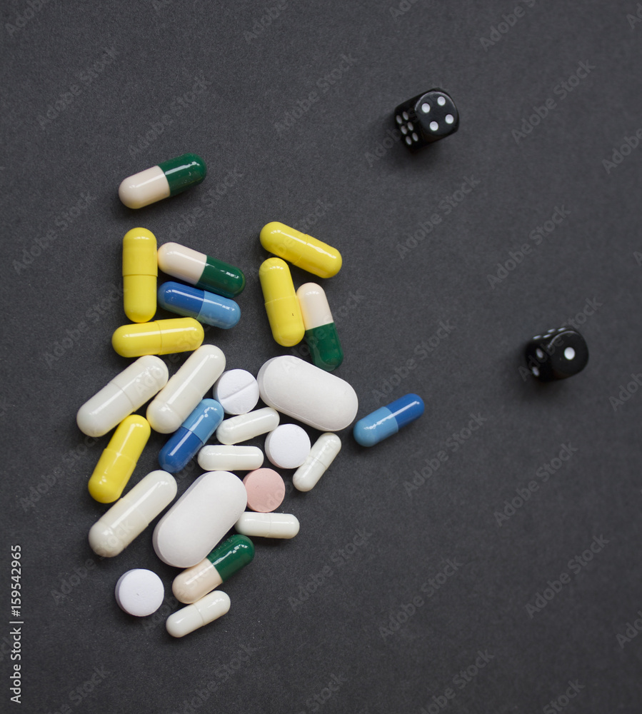 pills on spoon with leaves on a wooden background pills on spoon with leaves on a wooden background