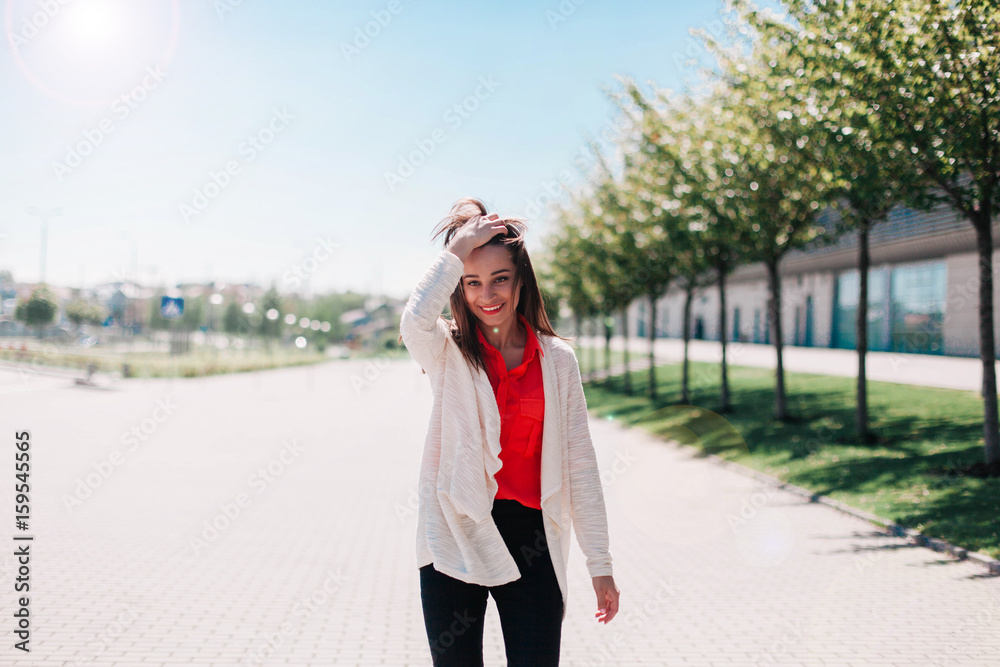 Brunette woman in white jacket stands outside Brunette woman in white jacket stands outside