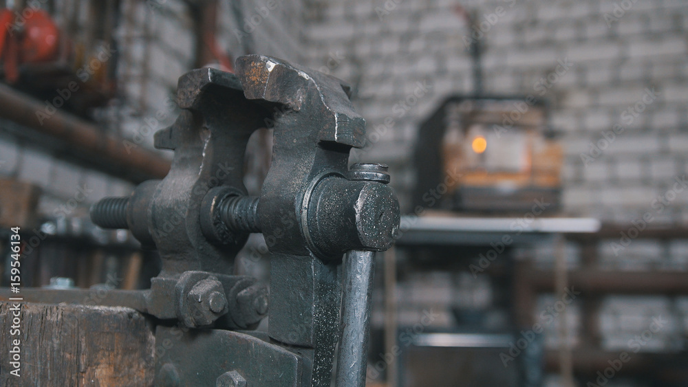 Inside forge workshop - steel vise, close up Inside forge workshop - steel vise, close up