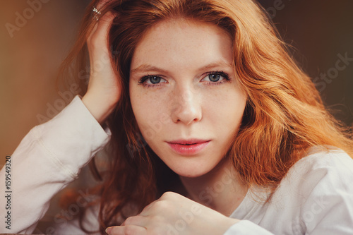 closeup indoor portrait of beautiful redhead woman  photo