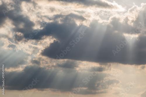 A close view of clouds with sunrays coming out through them © Massimo