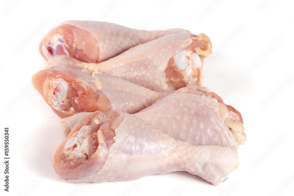 four raw chicken drumsticks isolated on white background four raw chicken drumsticks isolated on white background