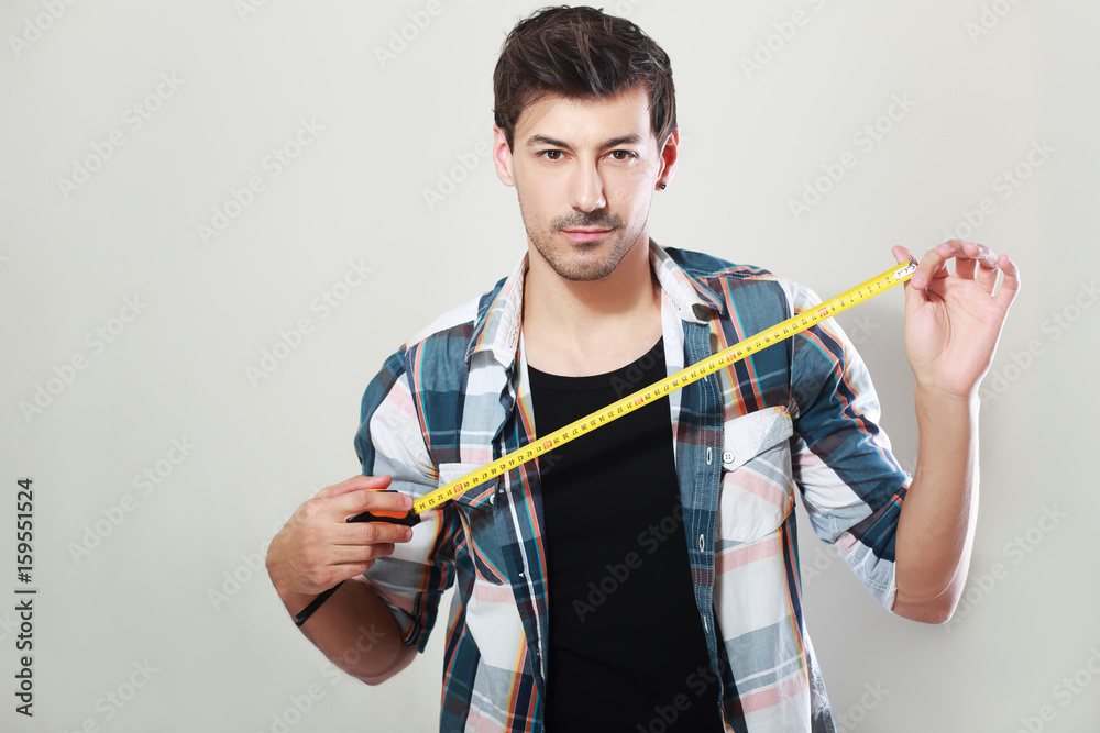 man holding measure tape