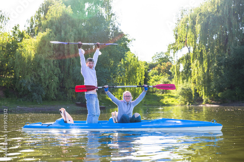 People enjou kayaking on beautiful river. Summer sunny time photo