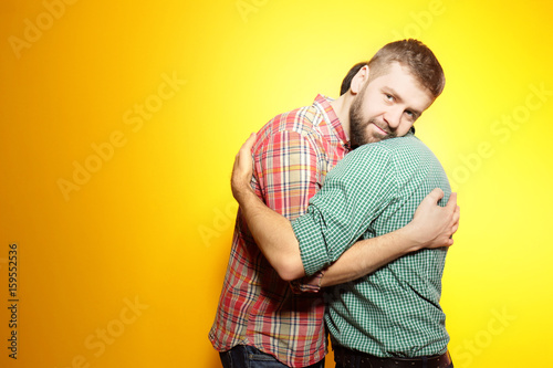 Happy gay couple posing on ...