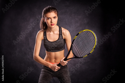 Young girl playing tennis with racket © Victor Studio