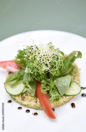 Green salad, parsley, tomatoes and fresh onions on a bed of quinoa  photo