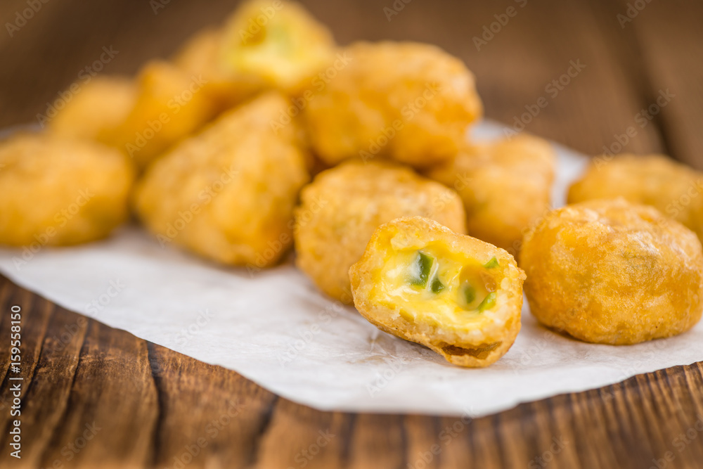 Chili Cheese Nuggets (selective focus) on vintage wooden background