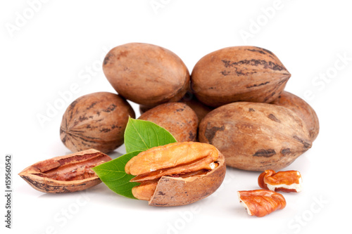 heap of pecan with leaves isolated on white background