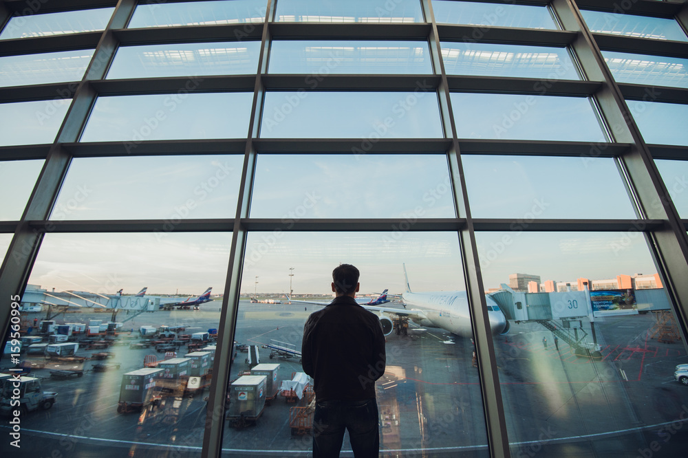 Silhouette of man waiting for the flight Silhouette of man waiting for the flight