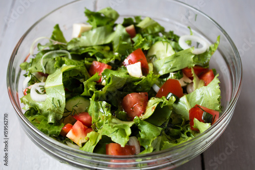 bowl of fresh salad with tomato and cheese onion photo