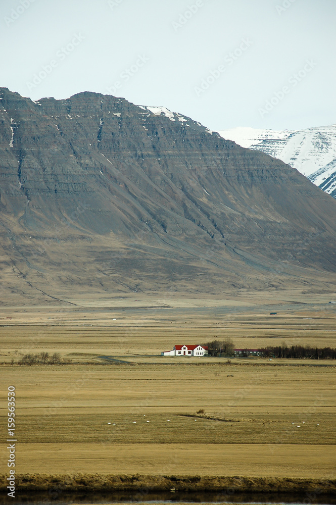 Upcountry house, rocky mountain, dry field, Iceland