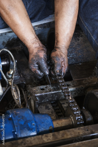 Hand during maintenance work of chain