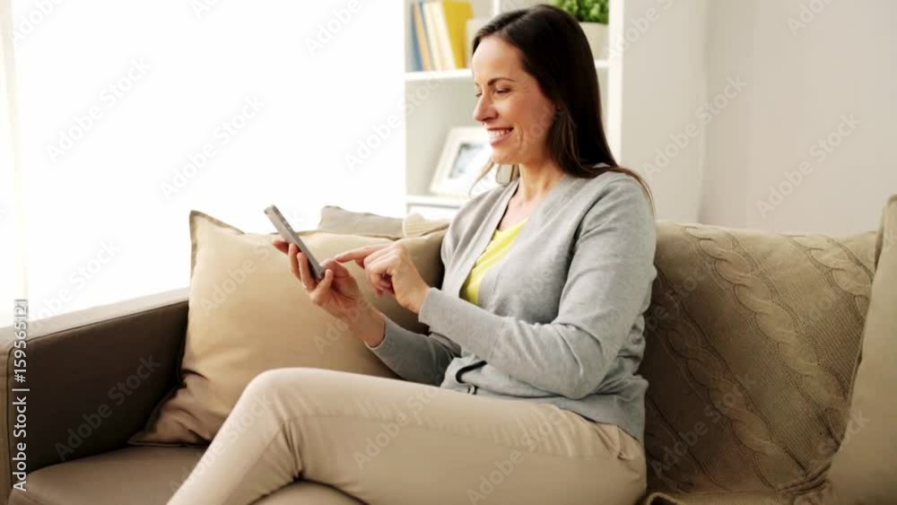 happy woman texting message on smartphone at home happy woman texting message on smartphone at home