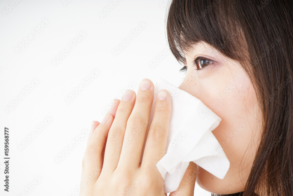 Young woman blowing her nose Young woman blowing her nose