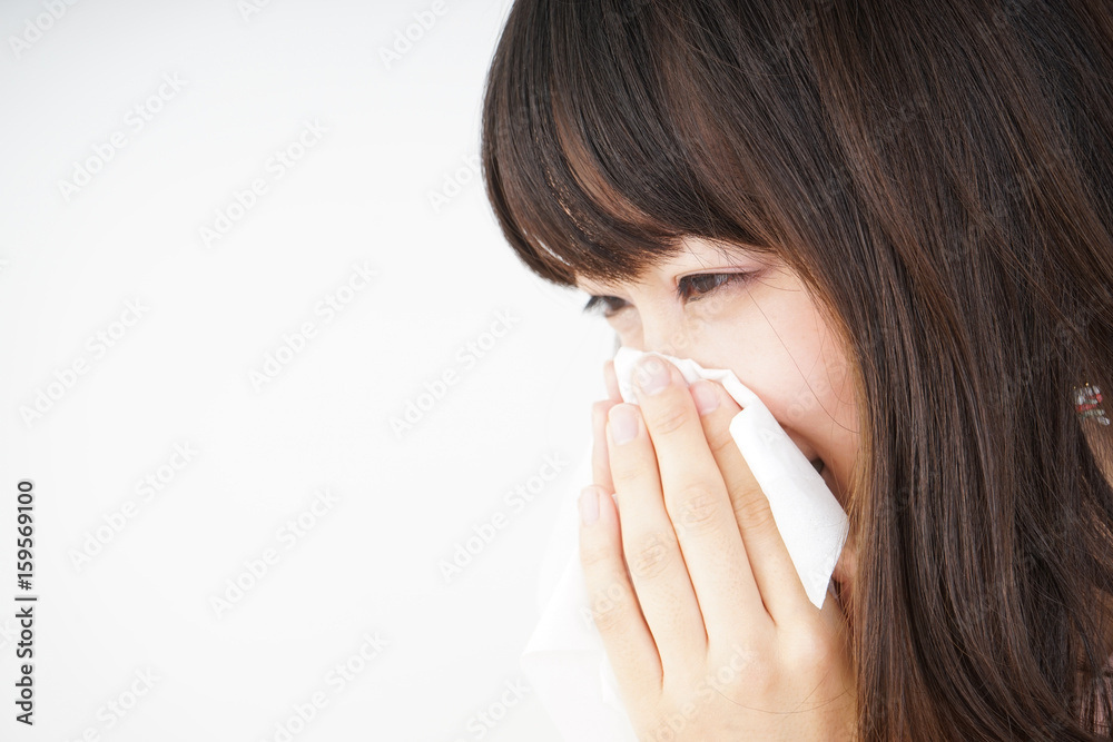 Young woman blowing her nose Young woman blowing her nose
