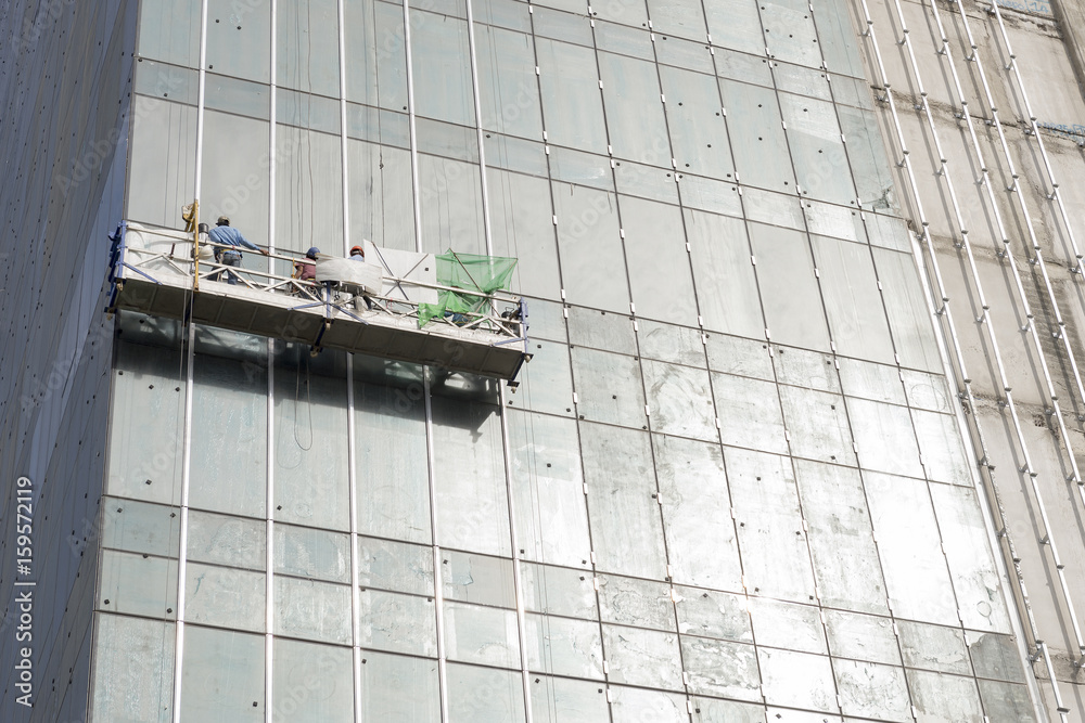 The gondola lift or scaffold for glass cleaner with the worker on the