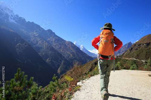 Young woman backpacker trekking at the himalaya mountains