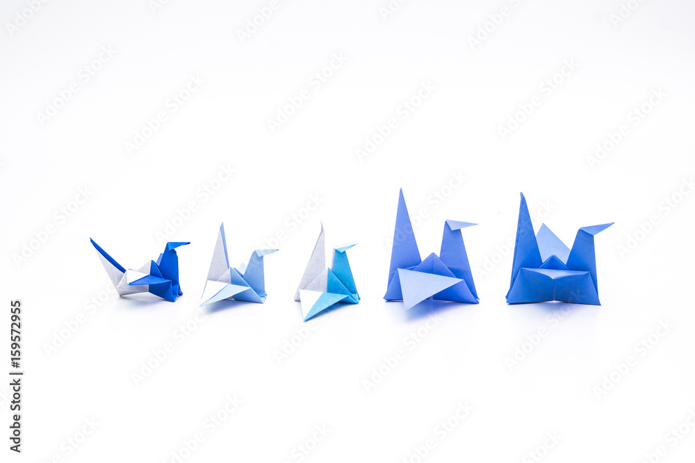 Family concept with big blue cranes leading among the small Family concept with big blue cranes leading among the small
