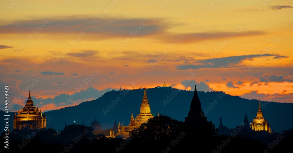 Sunset over Bagan with illuminated Pagodas and golden sky