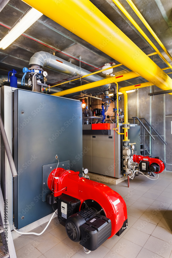 The interior of a modern gas boiler house with boilers, pumps, valves and a multitude of sensors