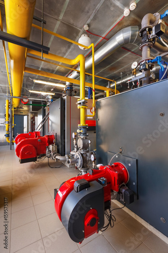 The interior of a modern gas boiler house with boilers, pumps, valves and a multitude of sensors © Aleksey Sergeychik