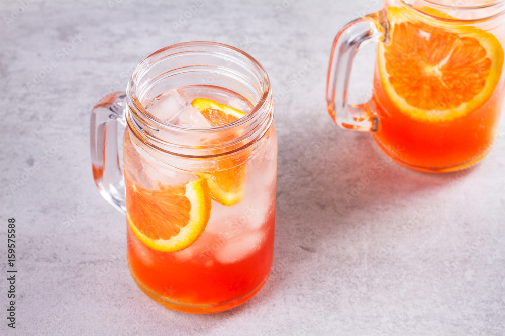 Campari and vermouth cocktail with oranges, garnished with thyme Campari and vermouth cocktail with oranges, garnished with thyme