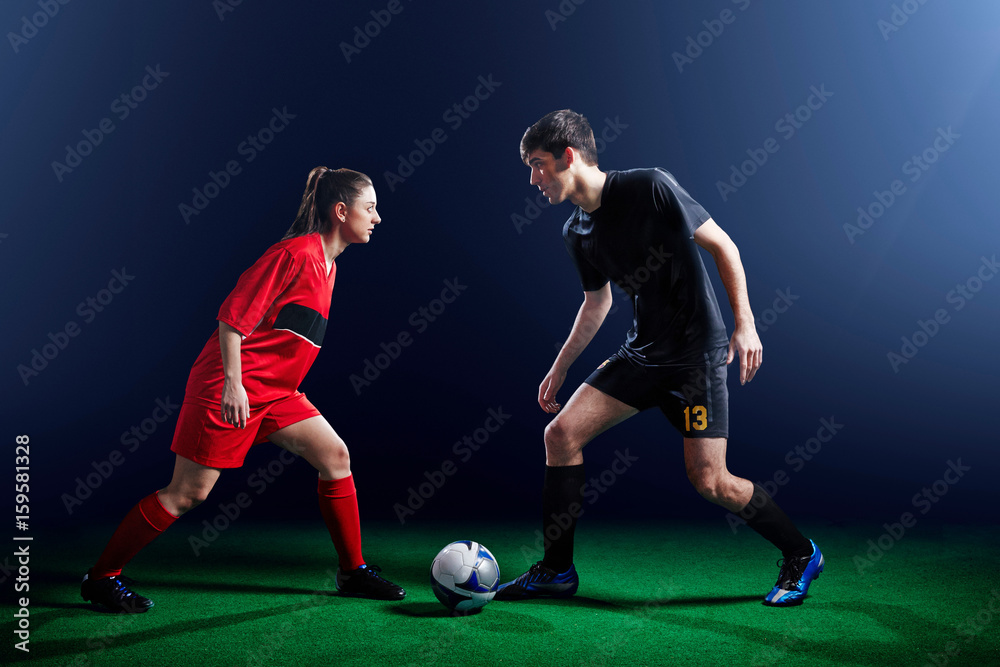 Male and female soccer players with ball Male and female soccer players with ball