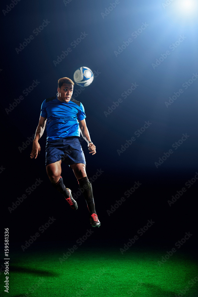 Male soccer player heading ball Male soccer player heading ball