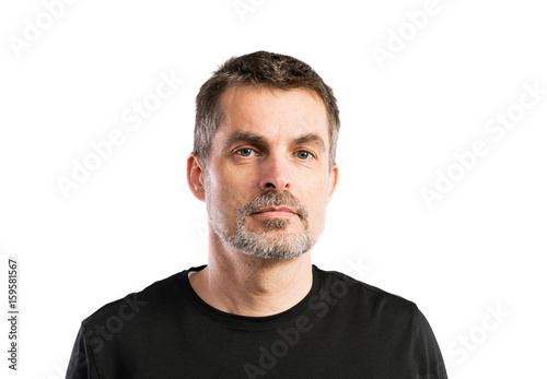 Mature hipster man in black t-shirt. Studio shot, isolated.