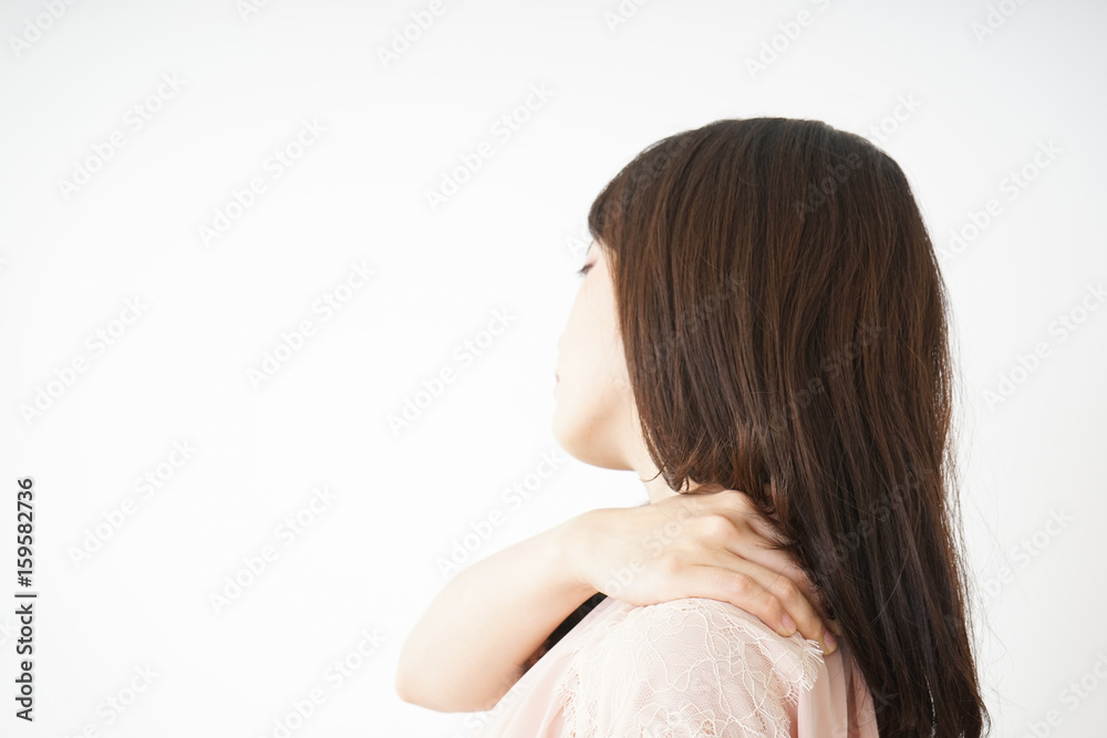 Obraz premium Young woman feeling stiff in her shoulders