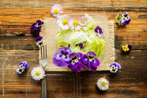 Spring salad with radishes, edible flower and sauce, selective focus