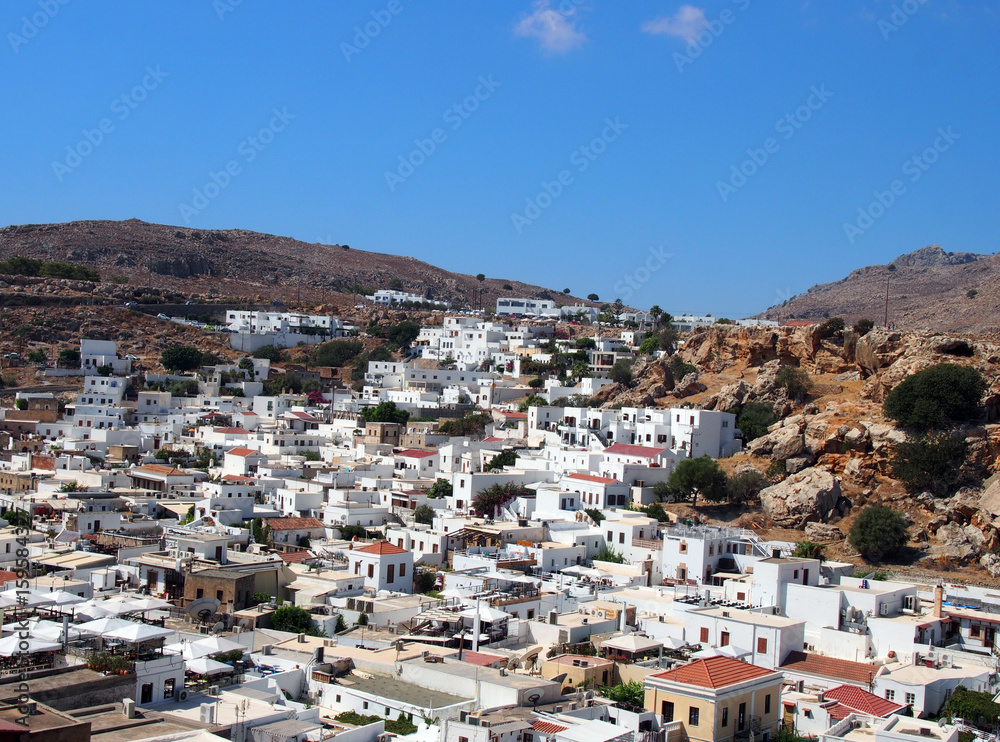 arial panoramic view of afandou village in rhodes with blue sky and mountains