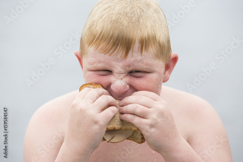 Portrait of boy eating sandwich