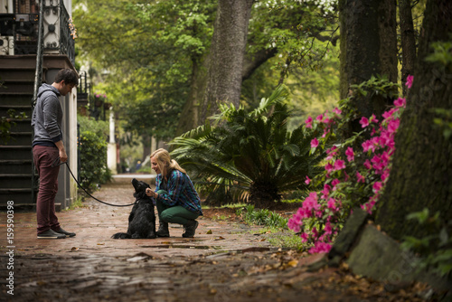 Couple with dog behind house, Savannah, Georgia, USA photo