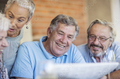 Portrait of smiling senior man having fun with his friends