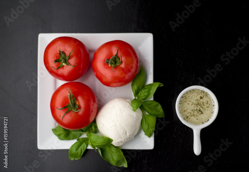 italian appetizer. tomatoes, basilic and mozarella, olive oil
