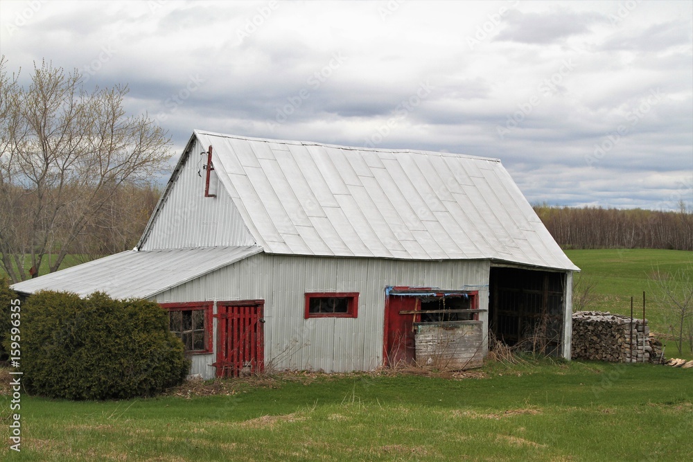 Old wood barn with red door and metal roof Old wood barn with red door and metal roof