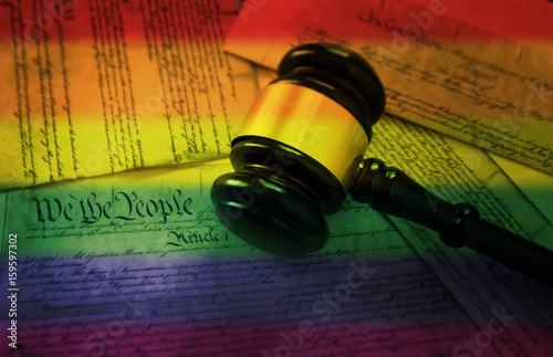 Rainbow flag gavel on America's Constitution