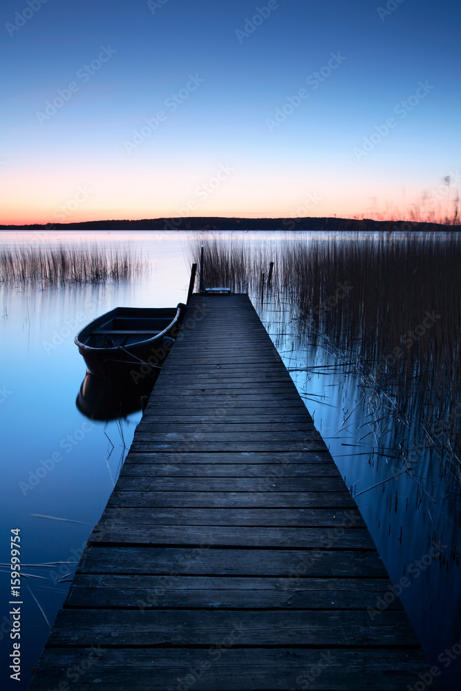 Calm Lake at Sunrise, Wooden Pier with Fishing Boat